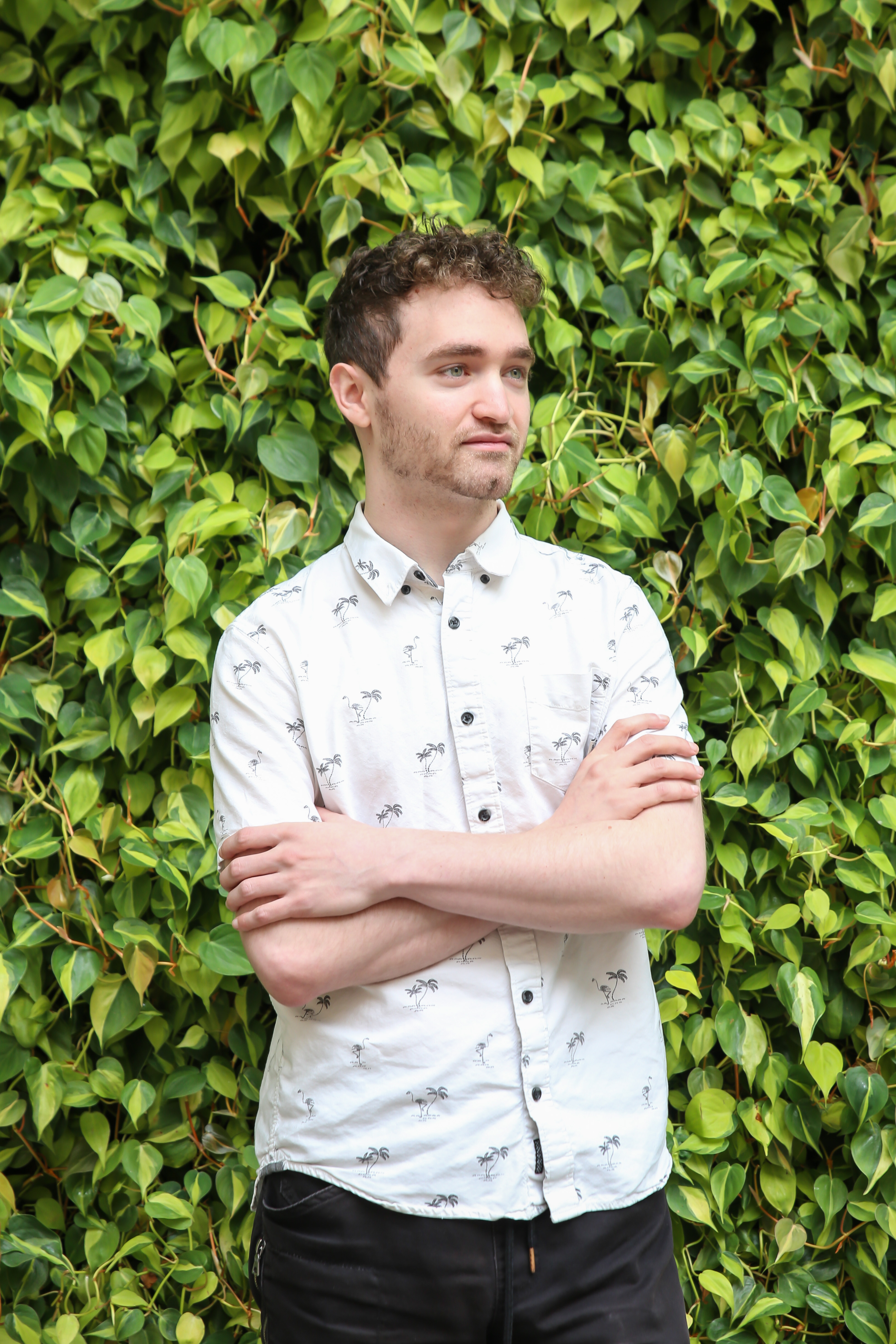 Devin in front of shrubbery
